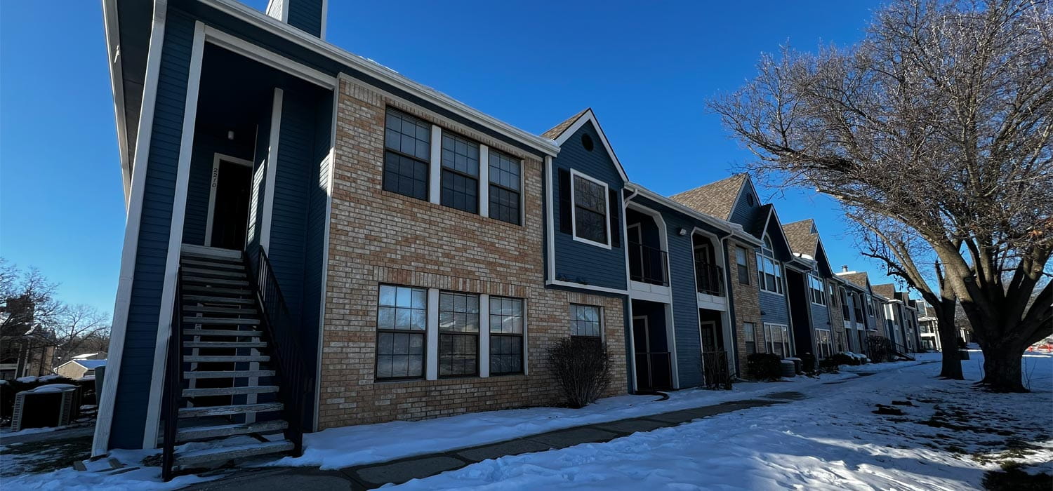 Navy blue apartment exteriors with white trim, repainted by painters in Northeast Kansas