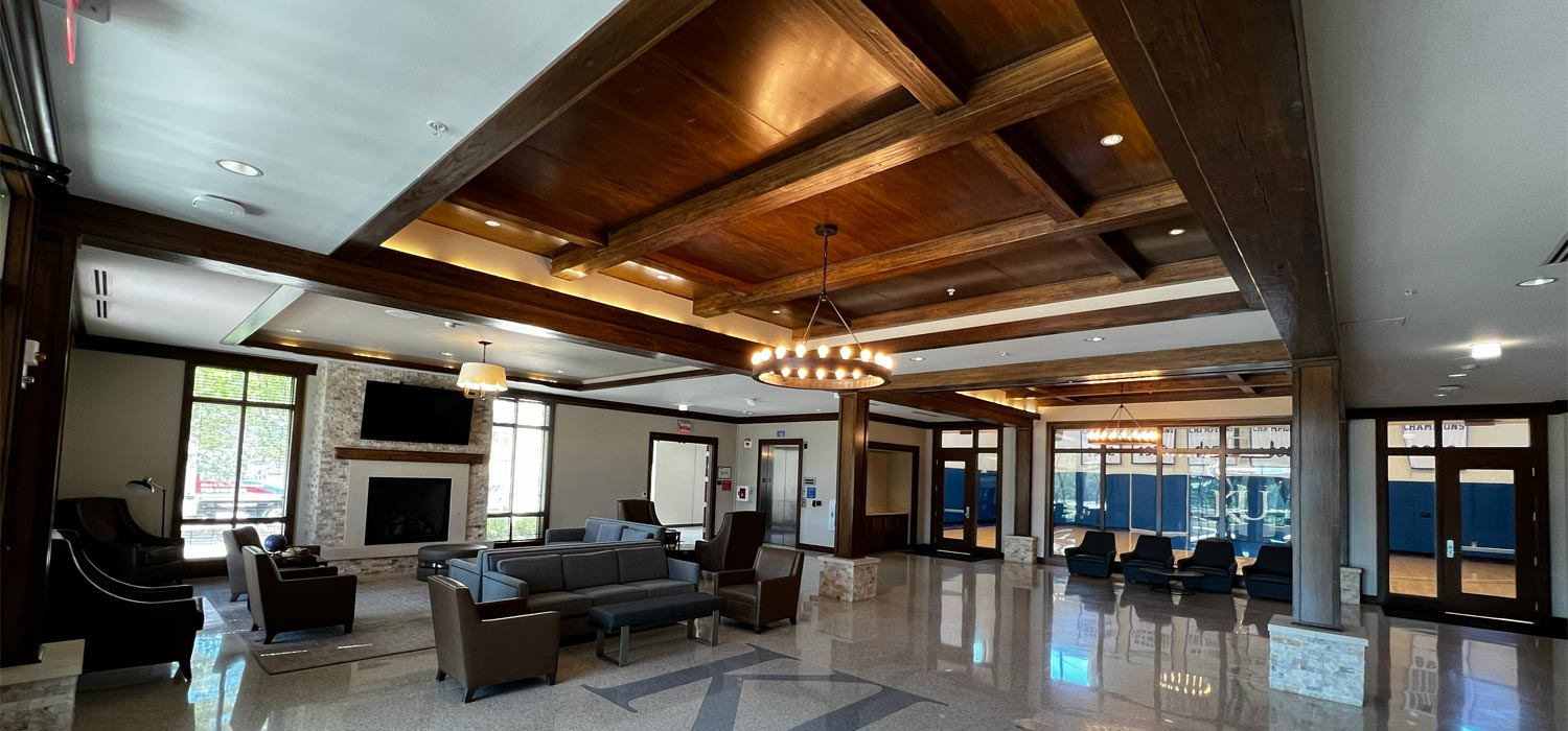 Commercial lobby with neutral walls and dark wood beams, painted by painters in Tonganoxie, KS