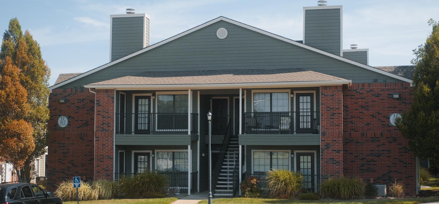 Apartment building with fresh sage green siding, painted by a painting company in Topeka, KS